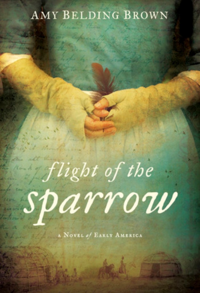 Book cover for Flight of the Sparrow by Amy Belding Brown, featuring a woman in a colonial-era dress writing with a quill over a handwritten historical document, with an early American landscape in the background. 