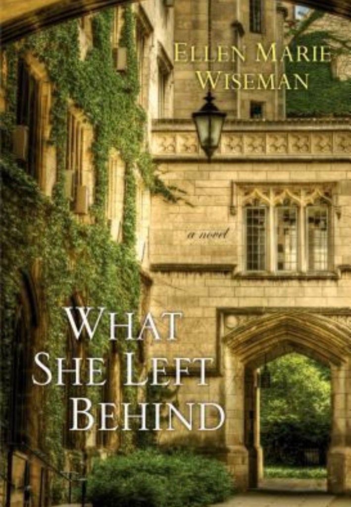 Book cover of What She left Behind by Ellen Marie Wiseman, featuring a historic brick building surrounded by trees and greenery. 